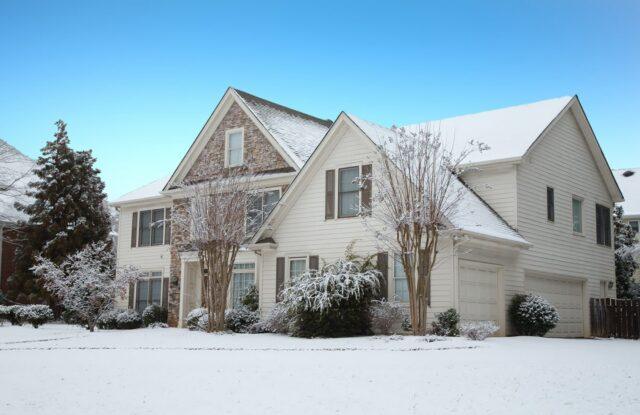 Home in winter with snow on roof